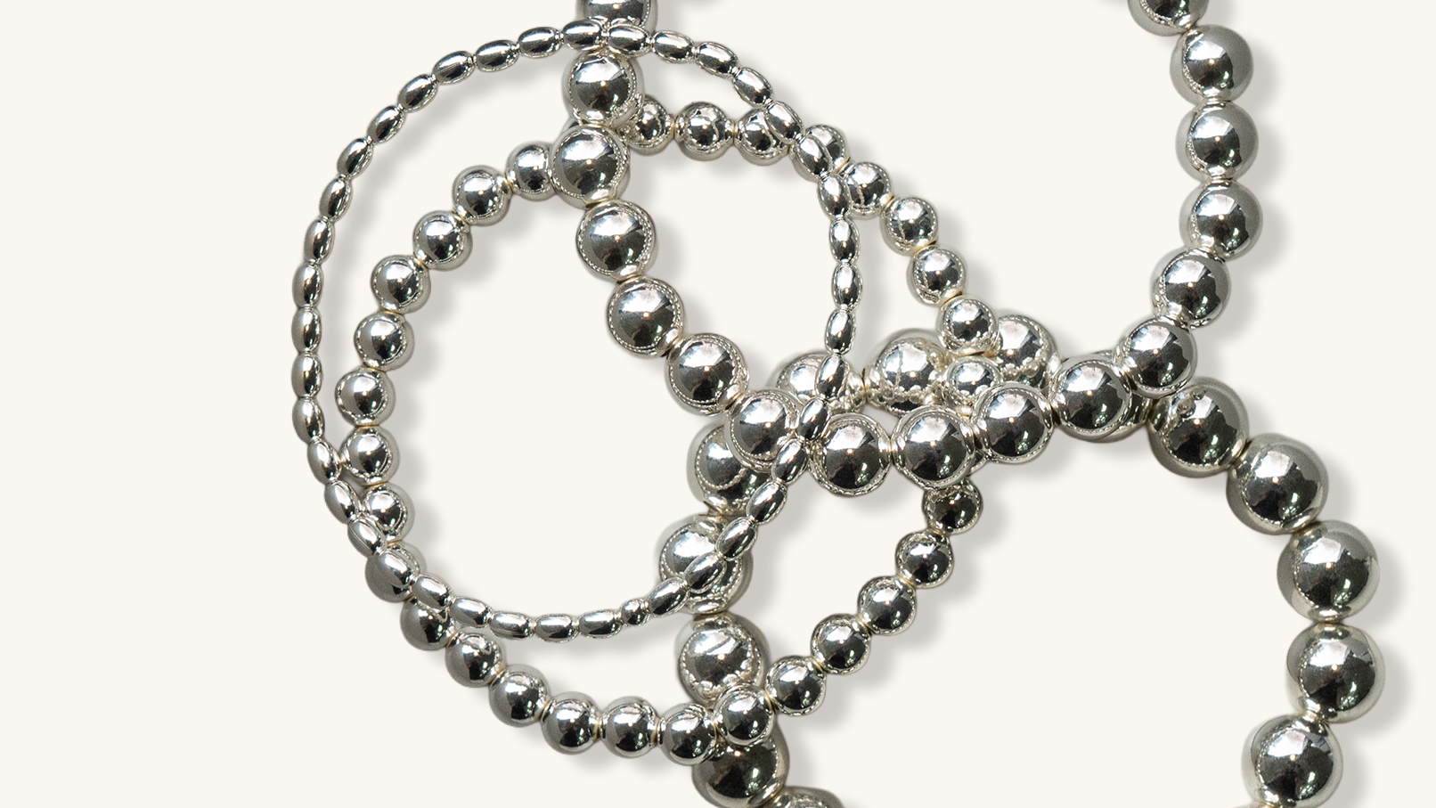 Silver beaded necklace on a white background